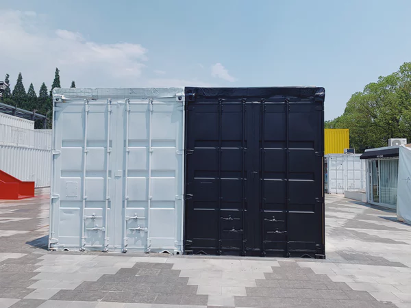Two storage containers next to each other. Left container is gray, right container is black.
